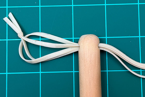 Thread the rubber band through