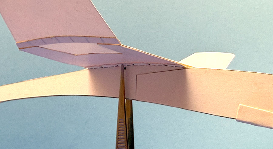 Balancing a Paper Airplane on Tweezers